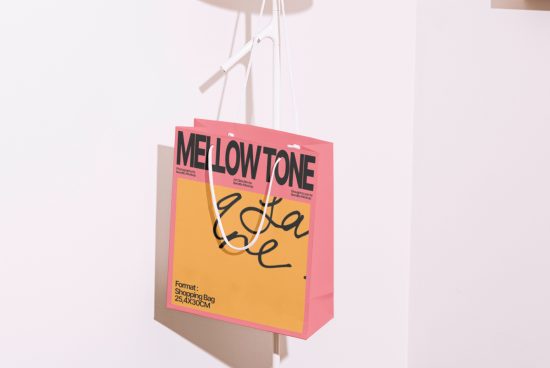 Pink shopping bag mockup with stylish typography hanging against a white background, ideal for showcasing branding and packaging designs.
