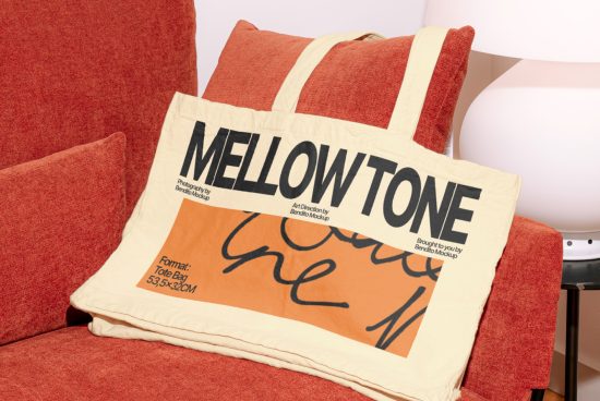 Canvas tote bag mockup on red chair with bold typography design, ideal for graphic presentations and branding projects.