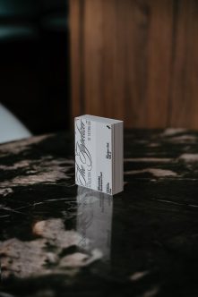 Single business card mockup standing upright on black marble surface