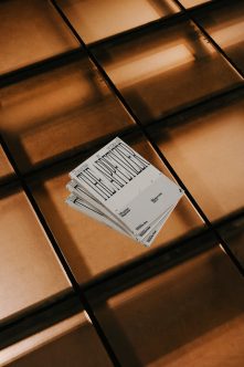 Stacked magazines with striped design detail in bright architectural sunlight