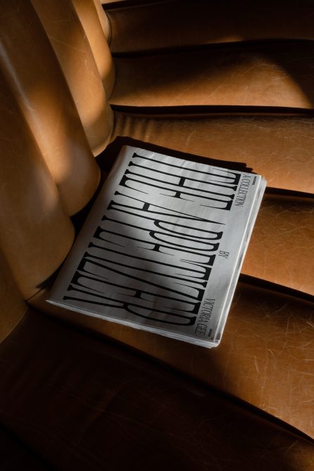 Magazine with horizontal line pattern layout on wooden floor with warm light