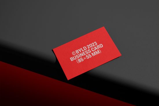 Professional red business card mockup on dark background, ideal for designers to showcase branding designs.