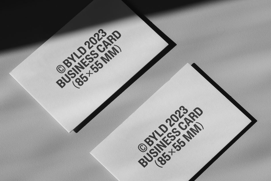 Business card mockup with shadow, two cards on a textured surface, 85x55 mm, ideal for presenting business card designs with a modern look.