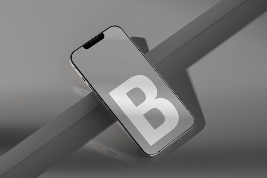 Modern smartphone mockup on gray background with letter B on screen, great for showcasing app design or branding presentations.
