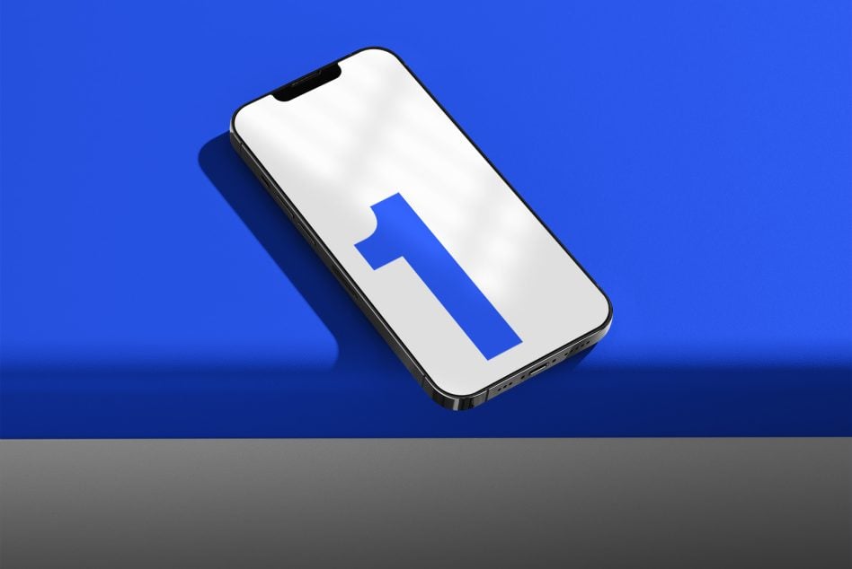 White iPhone on blue backdrop displaying bold blue numeral 1