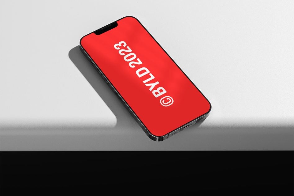Red iPhone tilted angle showing white vertical text on screen
