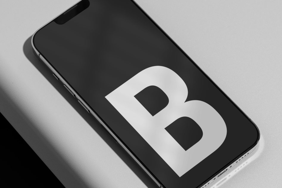 iPhone mockup displaying white letter B symbol on dark screen