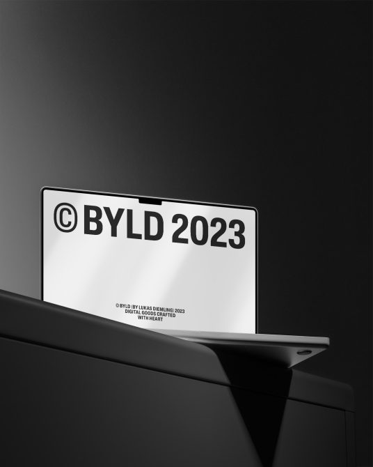 Laptop screen mockup with a minimalist black wallpaper, displaying the text BYLD 2023, ideal for presenting digital branding designs.