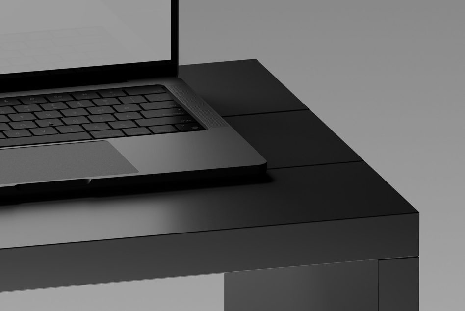 Minimalist laptop mockup on a dark desk, ideal for showcasing designs in a sleek, professional presentation for tech-related graphics.