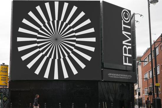 Large outdoor billboard with abstract radial design in black and white, potential mockup for advertising, urban setting with pedestrian.