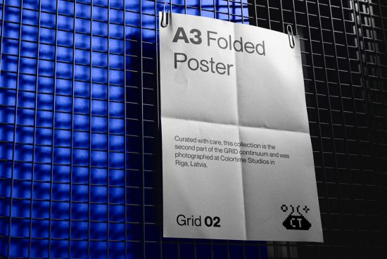 A3 folded poster mockup pinned on grid background, ideal for presenting design work, with space for text and branding.