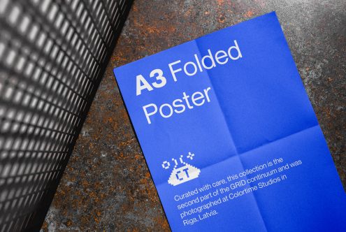 A3 blue folded poster mockup with a textured background, showcasing modern print design, ideal for graphic presentations in a portfolio.