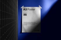 Off-white A3 poster taped to blue wall, pixelated icon, descriptive text below