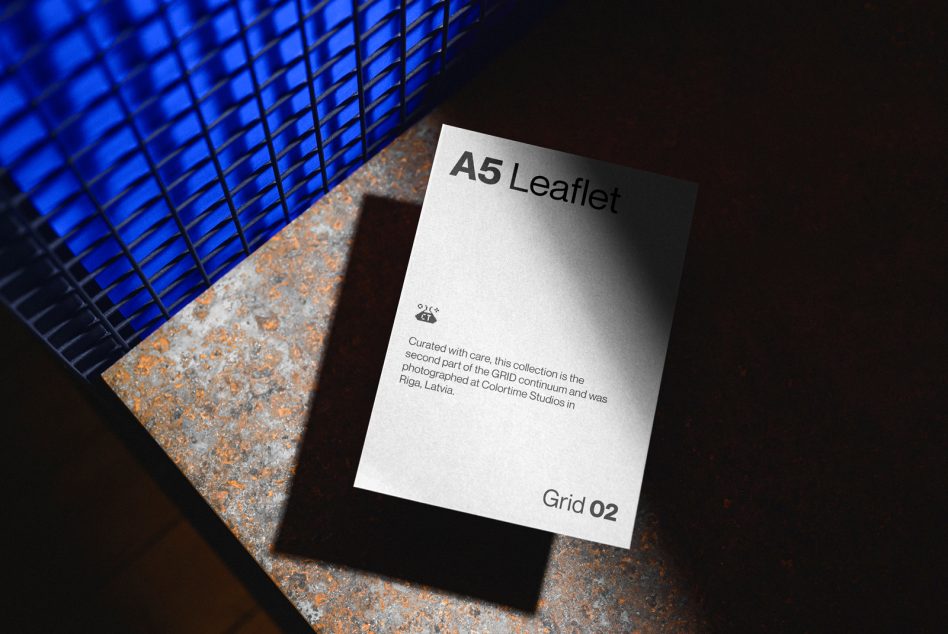 A5 leaflet mockup on textured surface with dramatic lighting, showcasing print design, perfect for designers portfolio presentation.