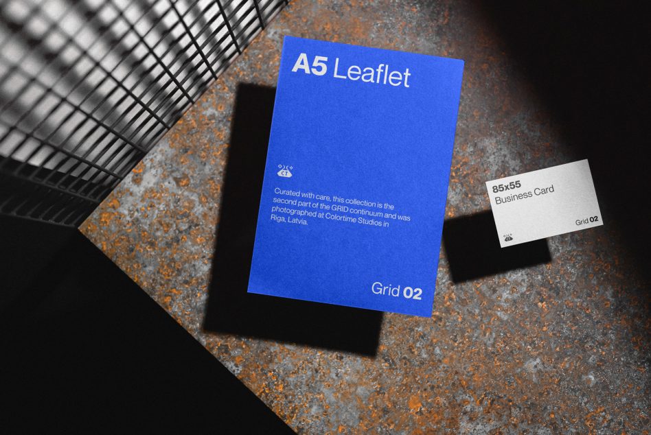 Blue A5 leaflet with white business card on industrial metal background