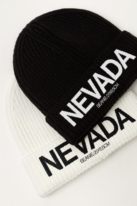 Black and white knitted beanies with bold NEVADA text, high-detail texture visible, ideal for mockup graphics in fashion and apparel design.