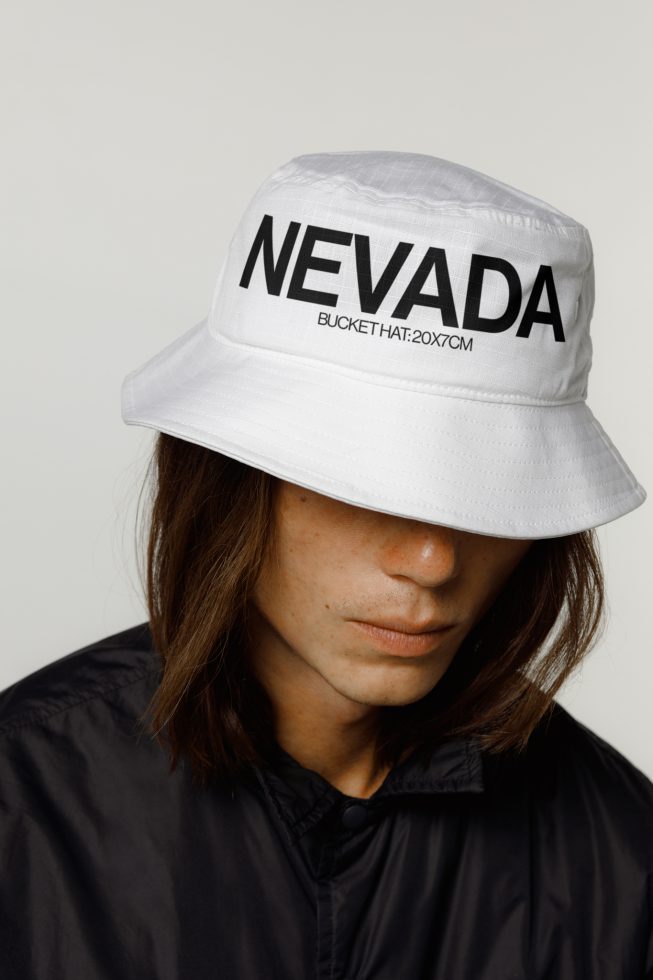 Fashionable unisex white bucket hat mockup on a model, ideal for designer presentations and apparel design showcase.