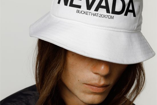 Close-up view of a stylish white bucket hat with bold text design worn by a model, ideal for fashion mockup graphics.