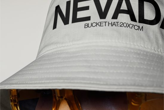 Close-up of a white bucket hat with bold black text, ideal for fashion mockups, advertising designs targeting accessory branding.