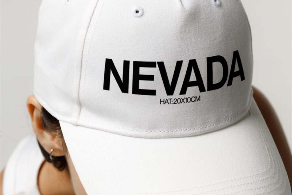 White baseball cap front view with bold NEVADA text, for mockup graphics design template, stylish apparel headwear marketing.