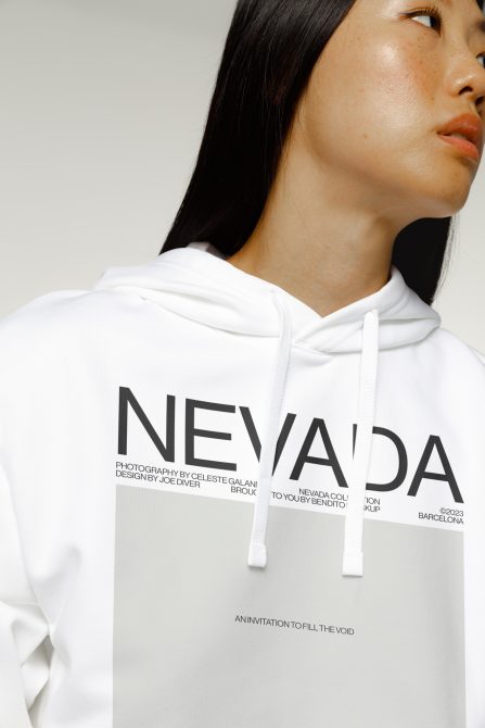 Woman in white hoodie showing chest print detail, Nevada text visible