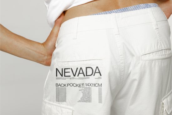 Close-up mockup of white trousers with text graphic design on back pocket for fashion apparel presentations, high-resolution, detailed texture.