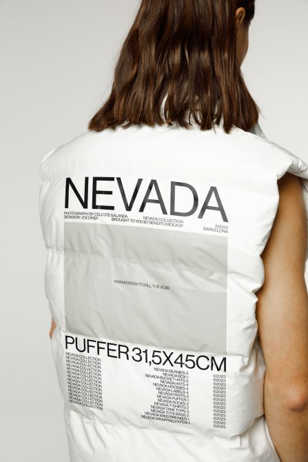 Back view of white puffer vest with large Nevada typography on upper back