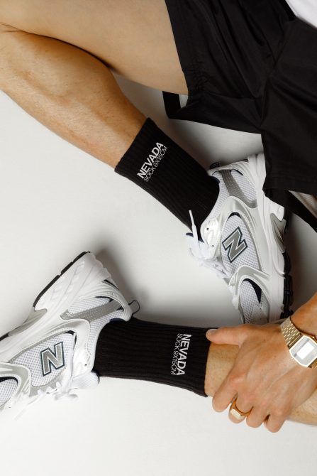 Close-up of fashion sportswear, detailing sneakers, socks, shorts, and watch for a sporty mockup or graphic design elements.