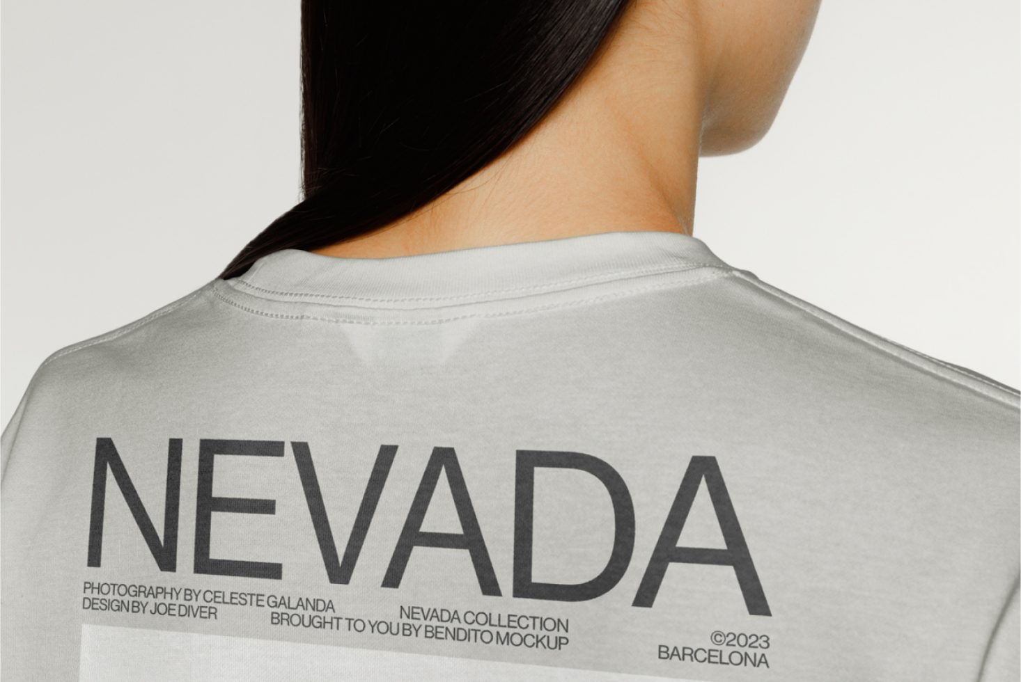 Back view of a t-shirt mockup with editable text design, model showcasing graphic tee, ideal for fashion branding and presentations.