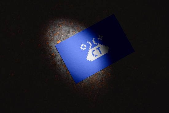 Business card mockup with pixelated logo design on a dark textured surface, spotlight illumination, graphic design asset.