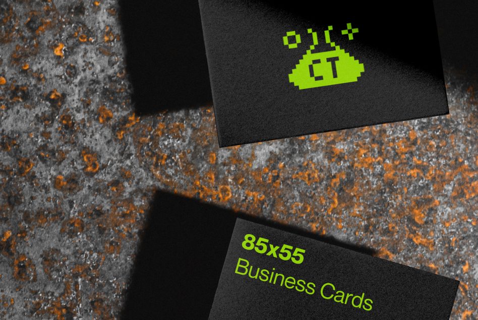 Black business cards with neon lime logo on rusty concrete background