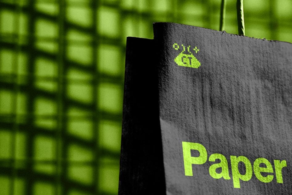 Black paper bag with neon lime logo, hanging against bright green grid backdrop