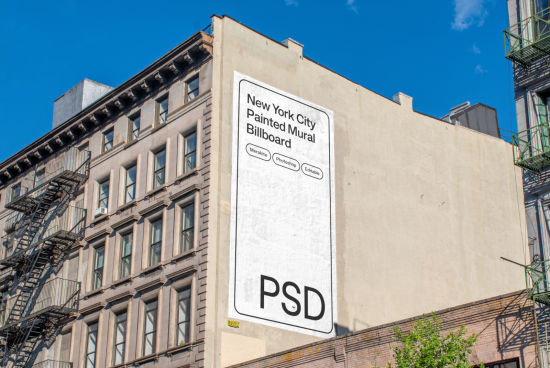 Urban billboard mockup on a New York building wall, clear blue sky, PSD graphic design template for advertising and branding.
