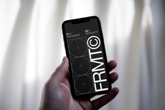 Hand holding smartphone displaying black and white graphic design interface, with abstract elements, for mockup and design presentation.