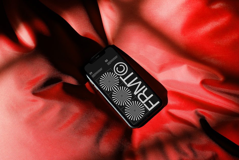 Phone with white geometric design on red textured fabric with glow