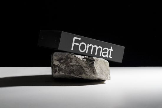 Black box with word Format resting on a stone against black background, ideal for mockup presentations, graphic design, and typography showcases.