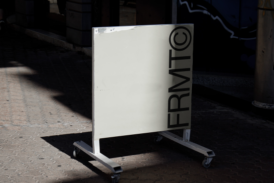 Blank sidewalk signboard mockup on wheels, urban setting with shadow patterns, perfect for designers to display branding graphics.