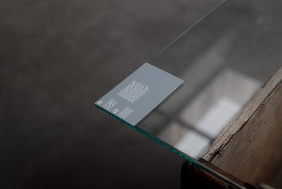 Glass table with modern clear business card mockup for presentation, sharp focus on print design in minimalistic style.