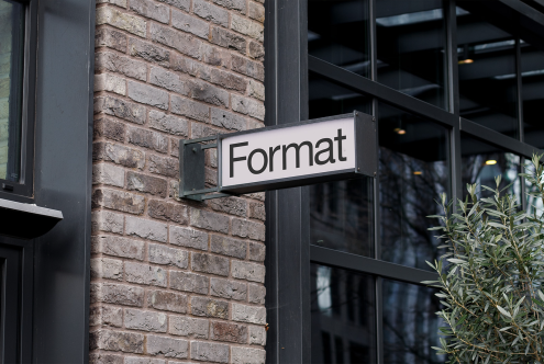 Storefront sign mockup on a brick wall for logo or branding design, with urban street background, suitable for designers and mockups category.