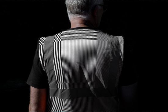 Rear view of elderly man wearing patterned shirt, dramatic lighting, high contrast, modern design, ideal for graphic template.