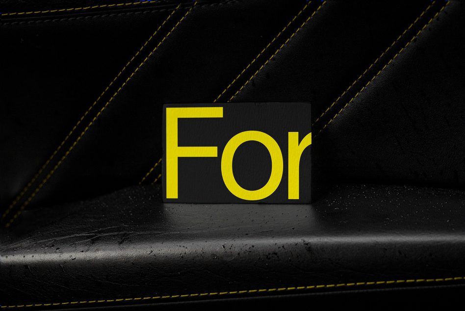 Black leather texture card mockup with bold yellow fonts displaying 'For', perfect for graphics and templates in design presentations.