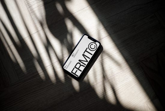 Smartphone mockup on wooden floor with dynamic shadows, modern design, digital asset for presentation, graphic design template.