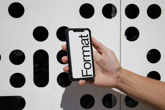 Smartphone screen mockup template held in hand against geometric patterned background for graphic designers.