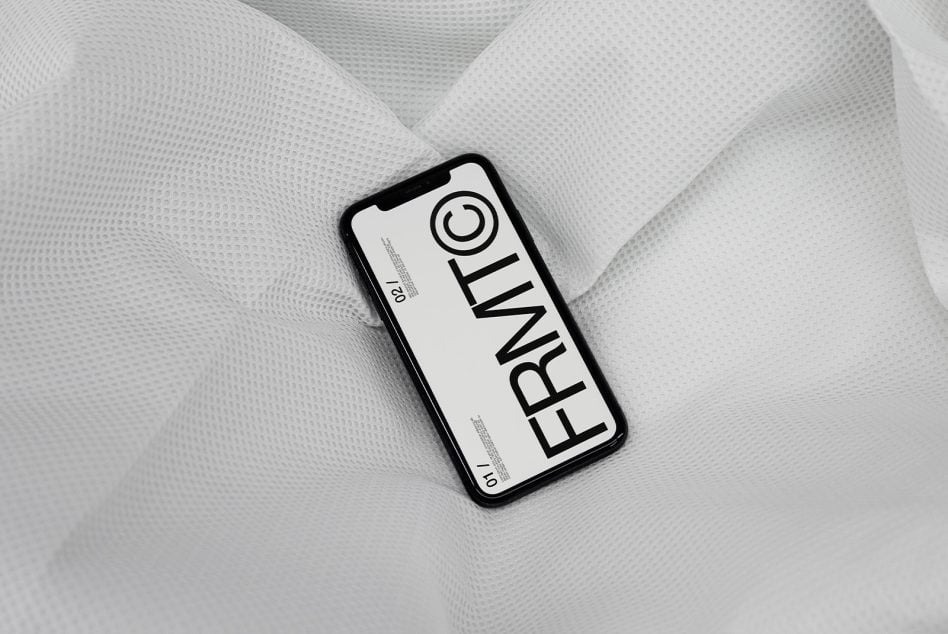Clean white phone mockup centered on crinkled white mesh fabric backdrop