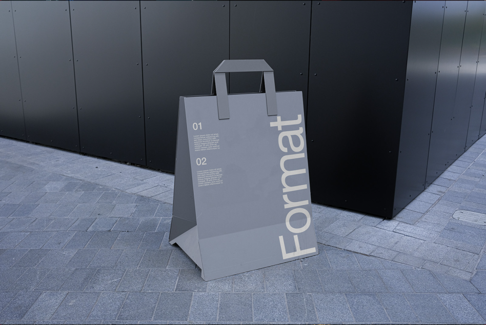 Stylish paper bag mockup for branding presentation on urban street background, suitable for designers to showcase products and designs.