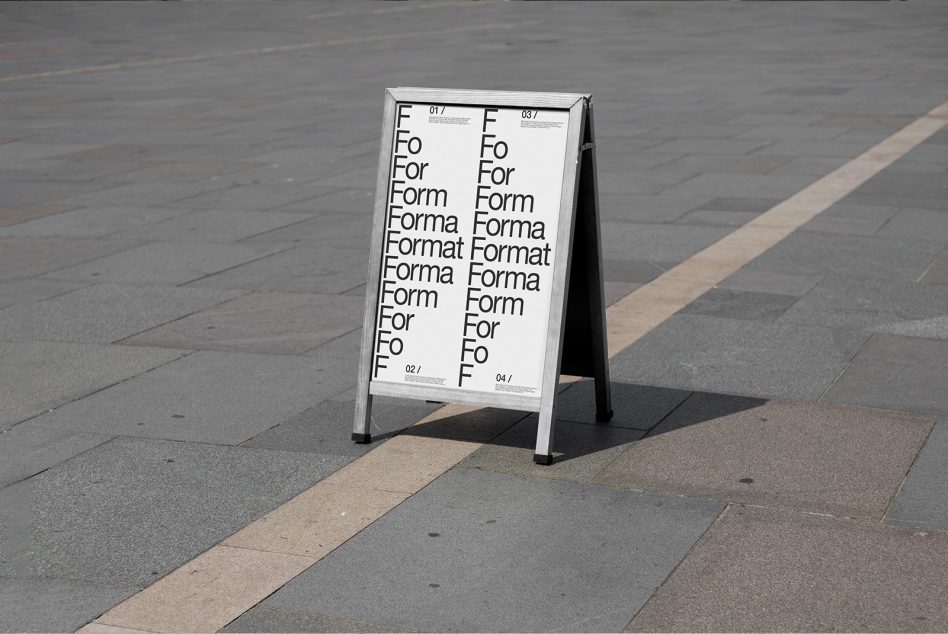 Modern typographic design on A-frame sign mockup standing on urban pavement, perfect for designers presentations and font display.