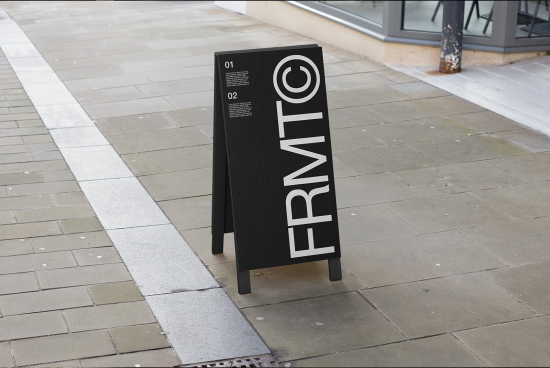 Black A-frame sidewalk sign mockup with minimalist white text design on urban pavement for outdoor advertising, display signage, and branding design.