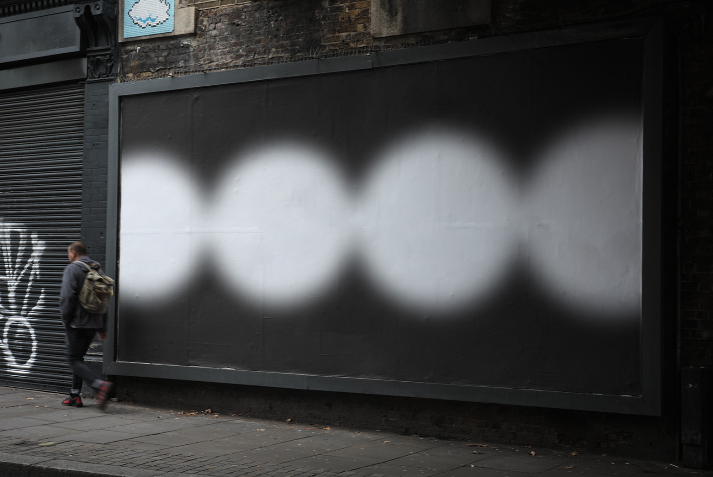 Urban billboard mockup with blurred lighting effect for outdoor advertising design, featuring pedestrian, city street background.