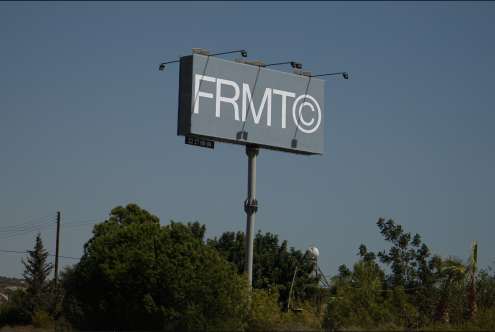 Billboard mockup in daylight with clear sky, ideal for presenting outdoor advertising designs to clients, perfect for graphics category.