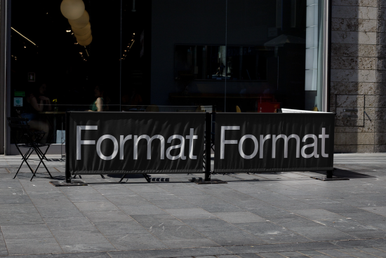 Outdoor cafe barrier with bold sans-serif font reading "Format Format", showcasing typography design in a real-world setting.